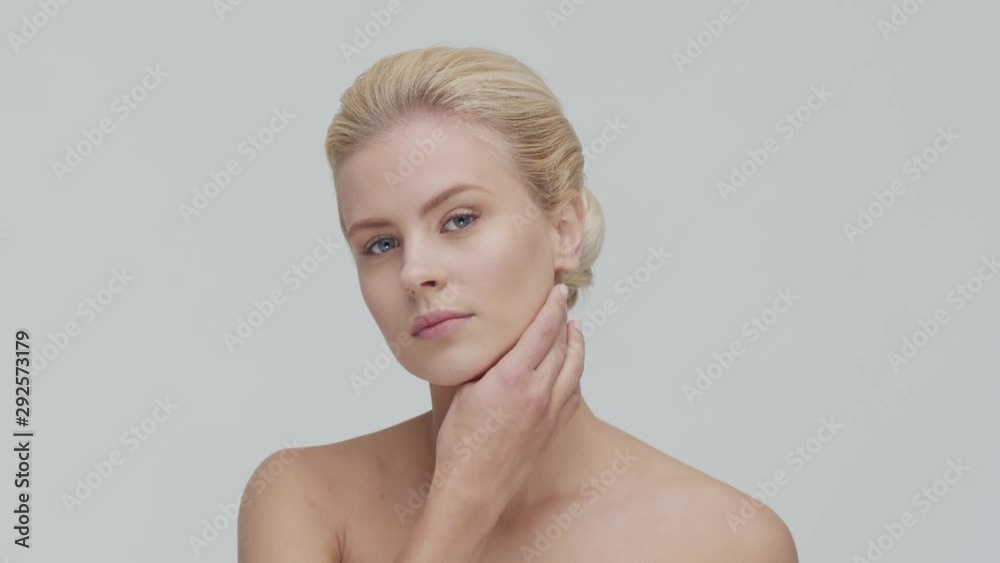 Studio portrait of young, beautiful and natural blond woman applying skin care cream. Face lifting, cosmetics and make-up. Studio portrait of young, beautiful and natural blond woman applying skin care cream. Face lifting, cosmetics and make-up.