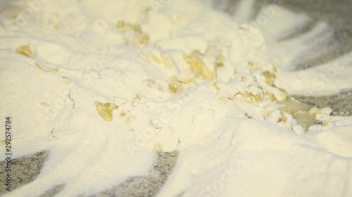 A man prepares to knead the dough for panzerotti or pies: pours water into flour and olive oil. Durum wheat flour, Senatore Cappelli photo