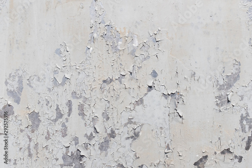 Grunge white metal wall with peeling paint, close-up background photo texture © romantsubin