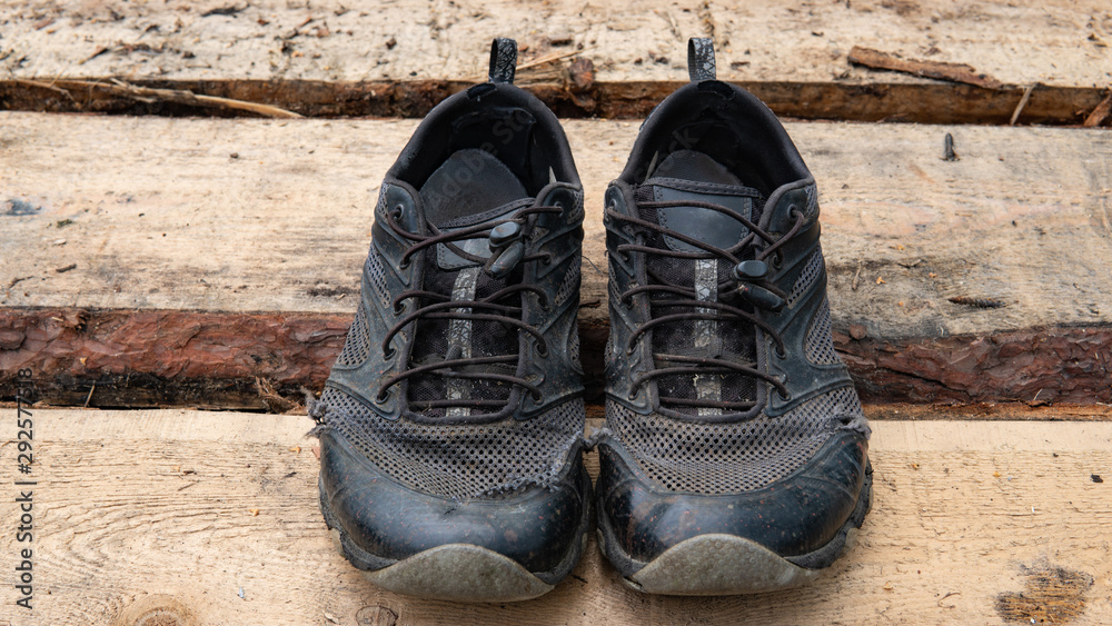 torn old shoes on the background of boards torn old shoes on the background of boards