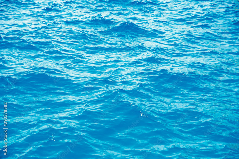 Natural background blue sea with waves, azure clear water beach. Aerial top view