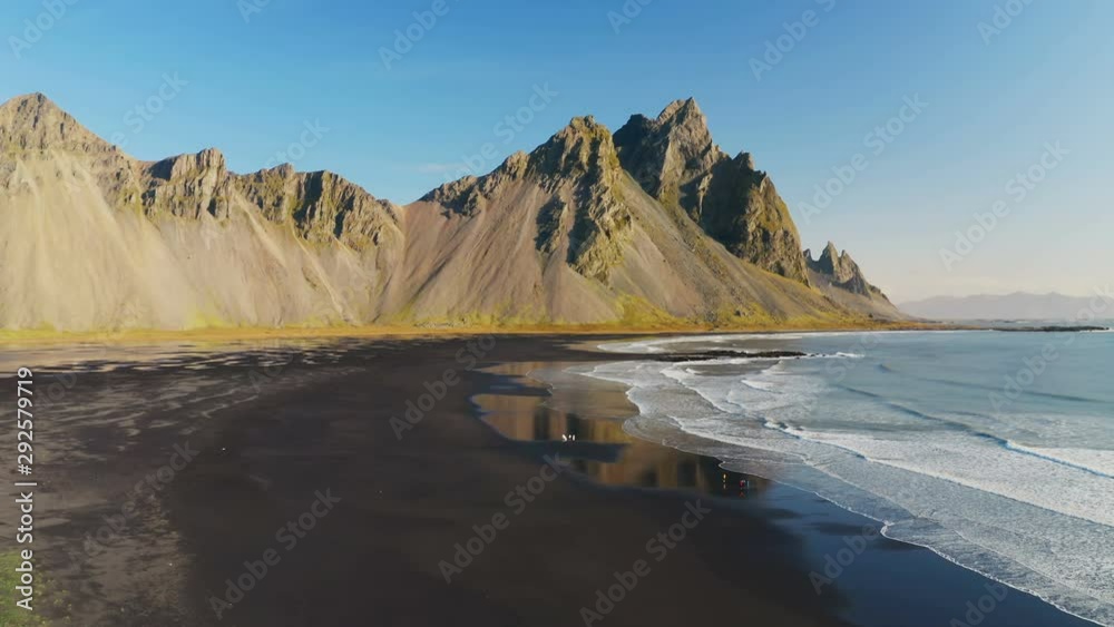 Epic aerial drone view flying over landscape of the black sand beach in Stokksnes. Vestrahorn mountain in the background. Nature and ecology concept background. Epic aerial drone view flying over landscape of the black sand beach in Stokksnes. Vestrahorn mountain in the background. Nature and ecology concept background.