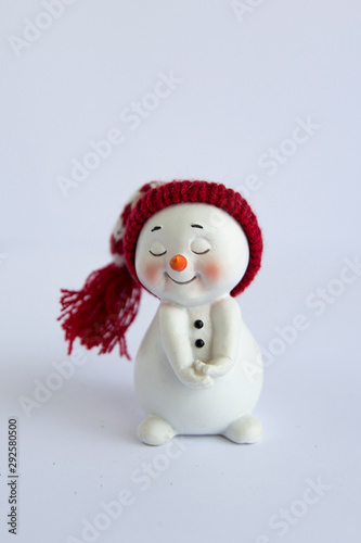 cheerful snowman in a fur hat and scarf, in a jacket on a white background. Concept of winter, christmas and new year. Isolated christmas symbol. © Наталия Лыкова
