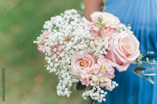 Wedding bouquet close-up Roses in a brides flower bouquet.Florist shop in daylight. Woman holding beautiful bouquet of flowers. Florist with her work. wedding bouquet hipster filter. copy space photos