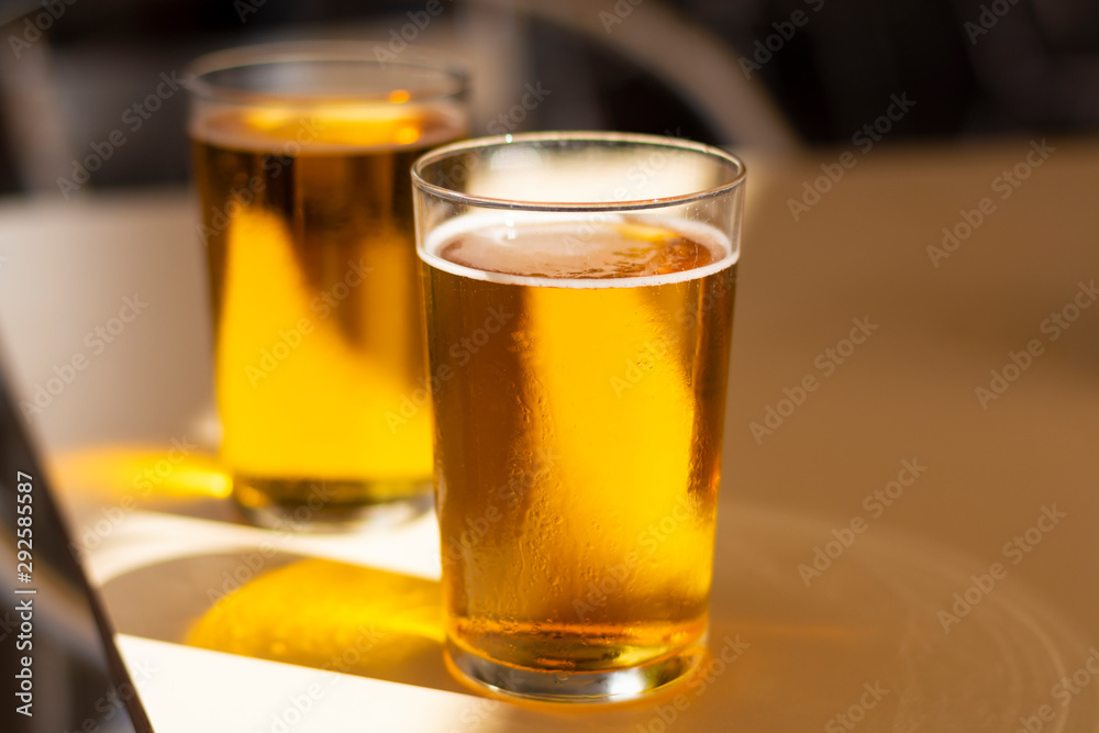 Cold amber color light spanish beer served in glass in outdoor cafe in sunny Andalusia, Spain Cold amber color light spanish beer served in glass in outdoor cafe in sunny Andalusia, Spain