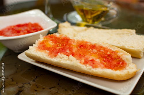 Traditional andalusian breakfast with bread toasts, fresh ground tomatoes and olive oil