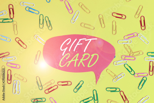 Handwriting text Gift Card. Conceptual photo A present usually made of paper that contains your message Flat lay above empty paper with copy space and colored paper clips