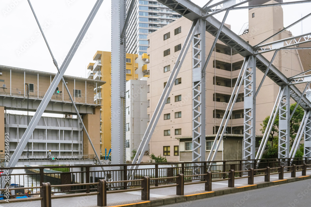 Japanese abstract urban background featuring details of coastal defense with  flood gates, bridge, city buildings and urban infrastructure in Tokyo downtown in Ginza district.   