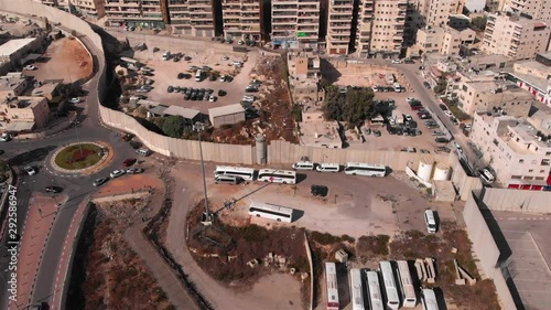 Aerial Footage of Army Watch Tower And Concrete wall Divide isreal and Palestine Drone Footage of Palestinian Refugge camp Shuafat With Security fence and Army Watch Tower photo