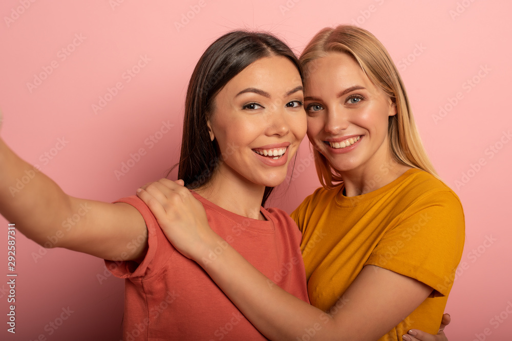 Friends do a selfie with smartphone. Joyful and happiness expression. Friends do a selfie with smartphone. Joyful and happiness expression.