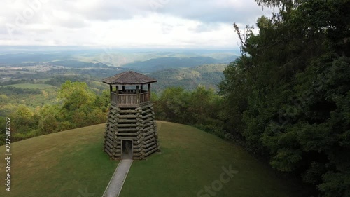 Aerial camera flying backwards to reveal Droop Mountain State Park’s overlook tower and its setting high on a mountain. photo