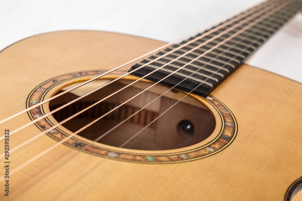 wood texture of lower deck of six strings acoustic guitar on white background. guitar shape wood texture of lower deck of six strings acoustic guitar on white background. guitar shape