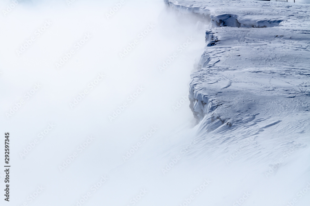 Obraz premium Snowy mountains above the clouds