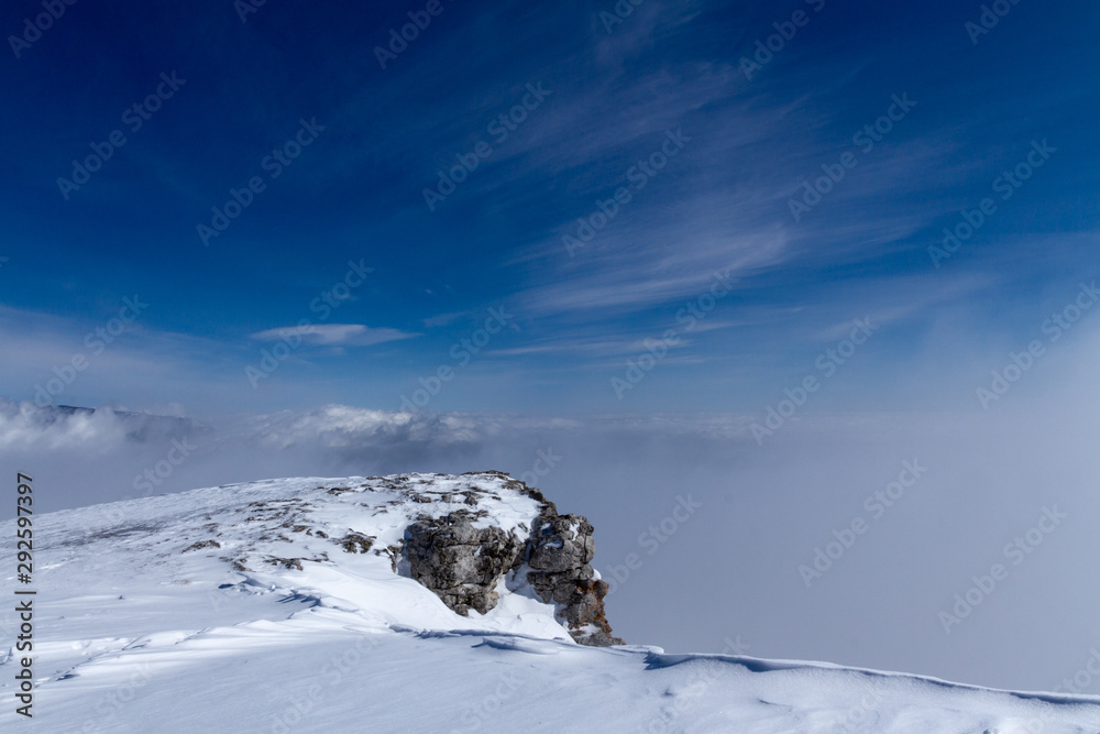 Snowy mountains above the clouds