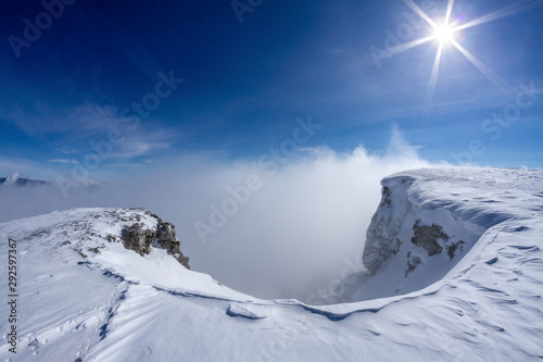 Snowy mountains above the clouds