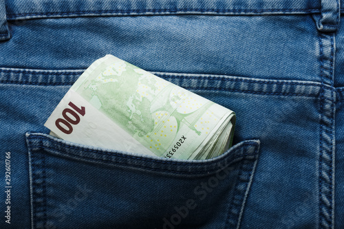 100 hundred euro banknotes on the beige background in jeans pocket top view with copy space. Money, business, finance, saving, banking concept, wealth, waste. Exchange Rates.