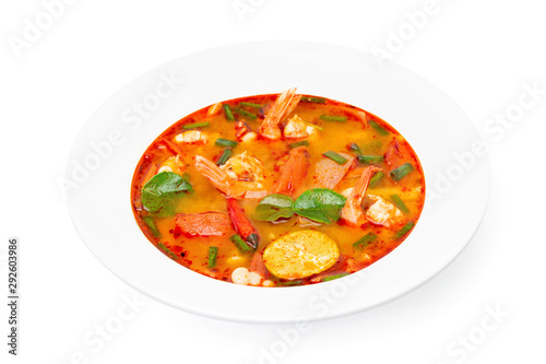 Closeup plate of traditional thai soup - tom yum kung isolated at white background.