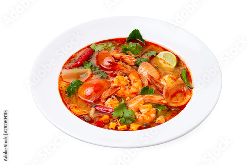 Closeup plate of traditional thai soup - tom yum kung with shrimps and tomatoes isolated at white background.