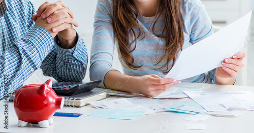 Foto Young couple looking at family finance papers