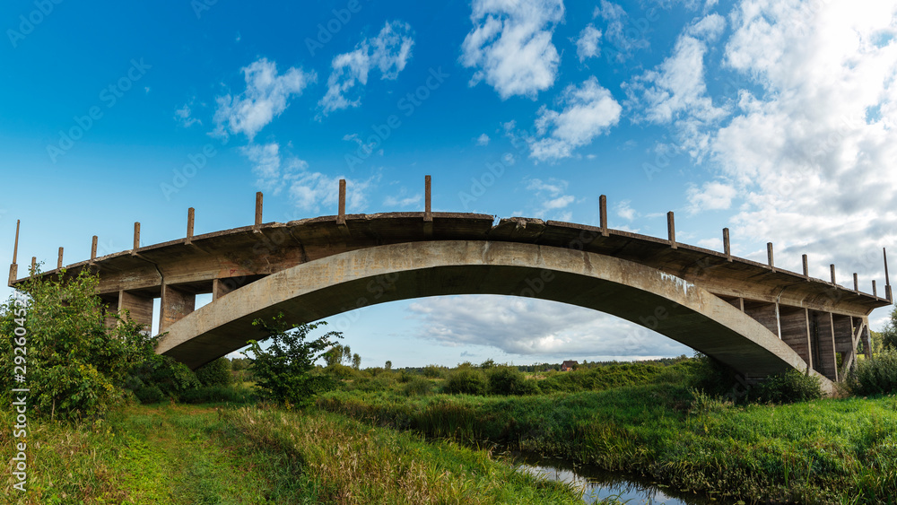 Big old abandoned bridge over small river. Big old abandoned bridge over small river.