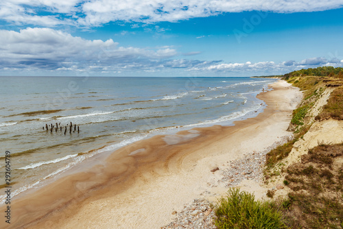 Rocky coast line of the Baltic sea in Latvia, during sunny summer day with blue sky.