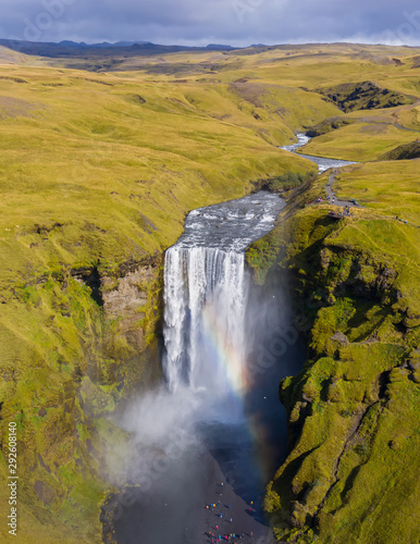 Iceland waterfall Skogafoss in Icelandic nature landscape. Famous tourist attractions and landmarks destination in Icelandic nature landscape on South Iceland. Aerial drone view of top waterfall.