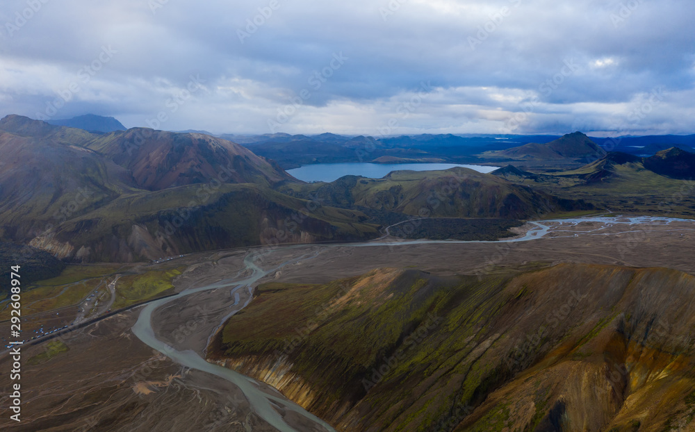 Iceland in september 2019. Great Valley Park Landmannalaugar, surrounded by mountains of rhyolite and unmelted snow. In the valley built large camp. The concept of world tours.