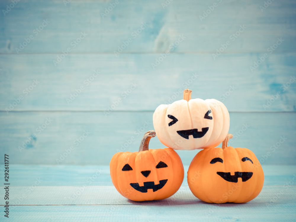 Fototapeta premium Orange and white pumpkins halloween decorate on blue wooden background. Use for halloween concept.