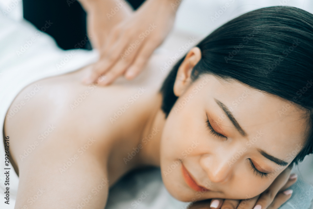 Beautiful young woman lying down on beds massage and spa at asian spa massage and beauty salon center, spa concept, massage concept Beautiful young woman lying down on beds massage and spa at asian spa massage and beauty salon center, spa concept, massage concept