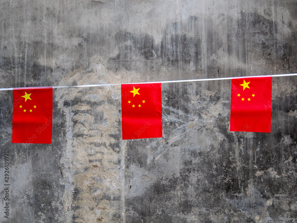 Chinese Flags against Concrete Wall