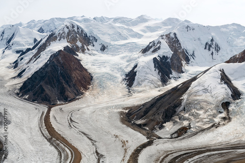 The Kaskawulsh Glacier flows at the base of the mountains in Kluane National Park, Yukon, Canada photo