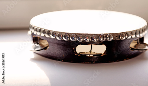 a tambourine lying in front of the window in the sun