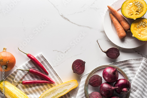 top view of plate with season autumn vegetables on marble surface photo