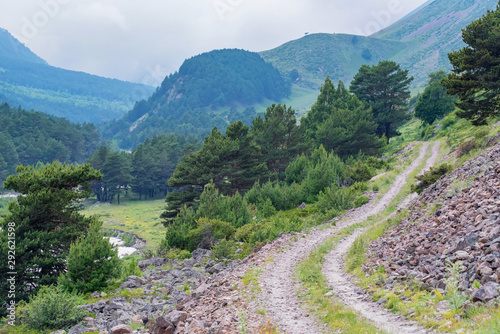 Picturesque landscape with narrow road in summer mountains photo