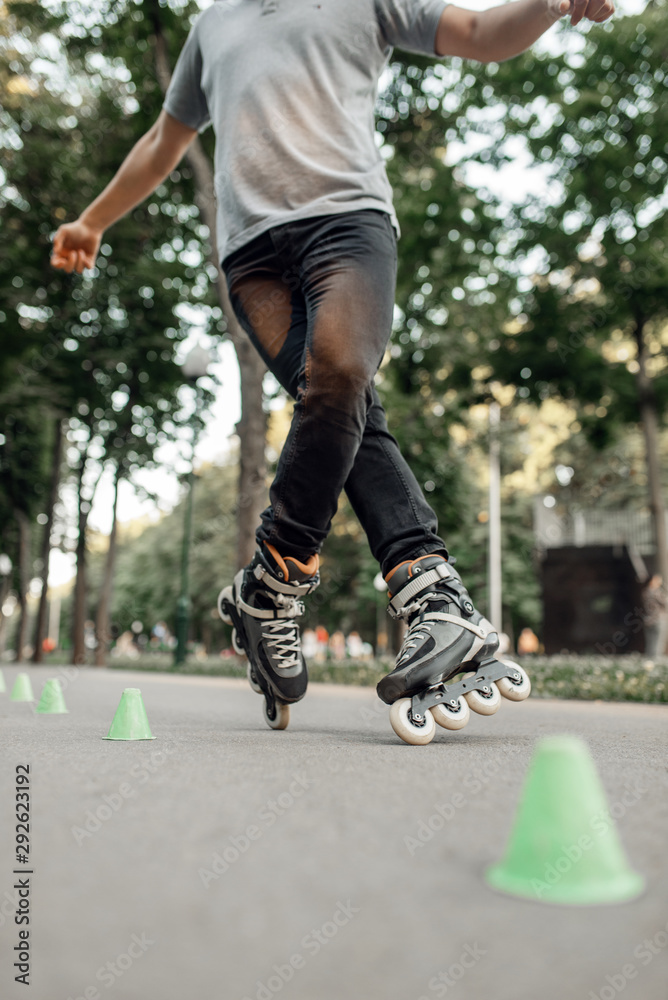 Fototapeta premium Roller skating, skater rolling around the cones