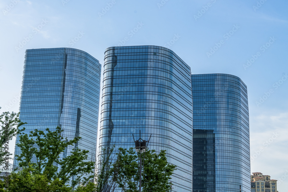 modern office building with green trees. modern office building with green trees.