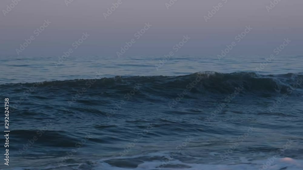 Beautiful crashing waves against the backdrop of a sunrise and scenery at Topsail Beach, a vacation community by the Atlantic ocean in North Carolina, USA Beautiful crashing waves against the backdrop of a sunrise and scenery at Topsail Beach, a vacation community by the Atlantic ocean in North Carolina, USA