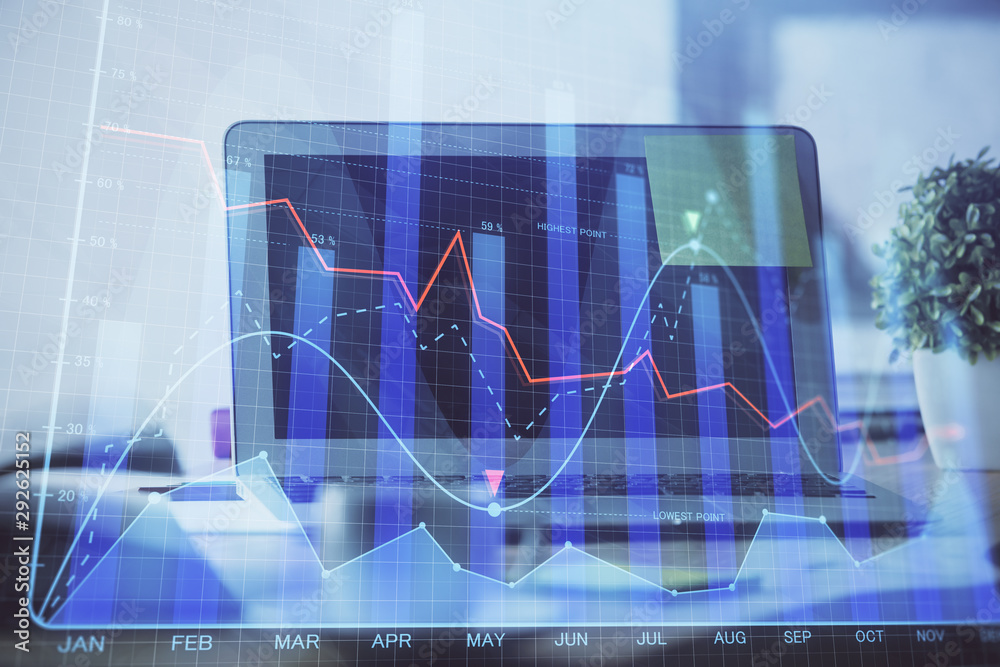 Stock market graph on background with desk and personal computer. Multi exposure. Concept of financial analysis.