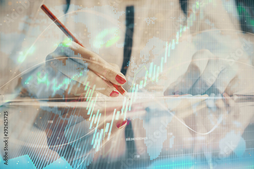 Wallpaper Mural A woman hands writing information about stock market in notepad. Forex chart holograms in front. Concept of research. Torontodigital.ca