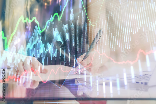 Wallpaper Mural A woman hands writing information about stock market in notepad. Forex chart holograms in front. Concept of research. Double exposure Torontodigital.ca