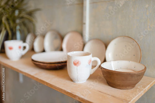 Kitchen utensils on shelf in pottery workshop