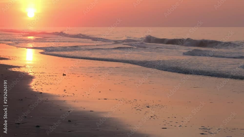 Beautiful sunrise, waves, and ocean scenery at Topsail Beach, a vacation community by the Atlantic ocean in North Carolina, USA Beautiful sunrise, waves, and ocean scenery at Topsail Beach, a vacation community by the Atlantic ocean in North Carolina, USA