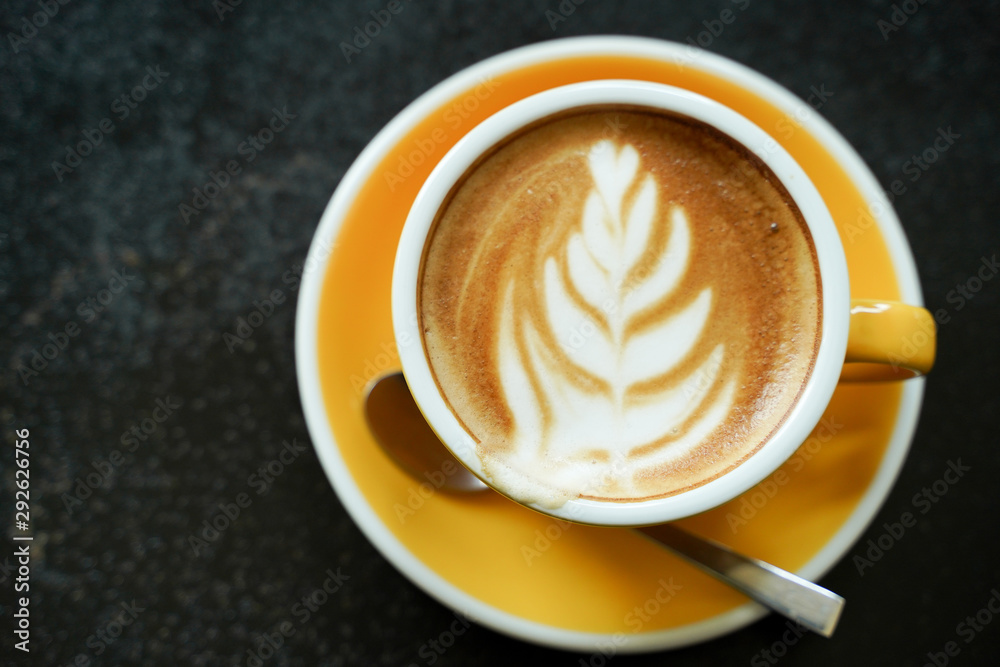 Coffee Latte leaf pattern face on black table Coffee Latte leaf pattern face on black table