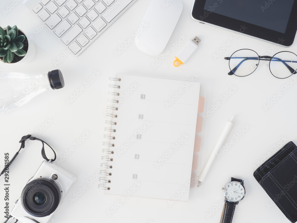 top view of office desk table with notebook, plastic plant, digital camera and keyboard on white background, graphic designer, Creative Designer concept. top view of office desk table with notebook, plastic plant, digital camera and keyboard on white background, graphic designer, Creative Designer concept.
