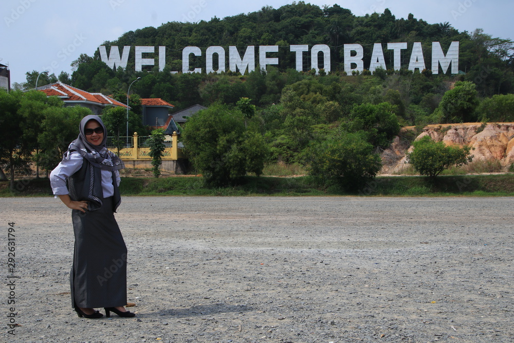 Welcome to Batam in Batam Island, Indonesia - August 7, 2019, Large welcome word to Batam island Indonesia, Beautiful landmark and tourist attraction-Iconic with beautiful woman
