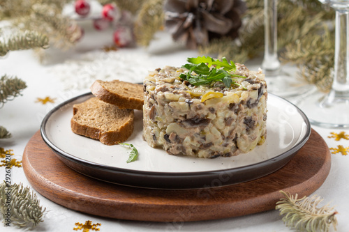 Salad with mushrooms, beef, potatoes and onions for new year, Christmas. Winter holiday, celebration, traditional Russian food. Portion feed
