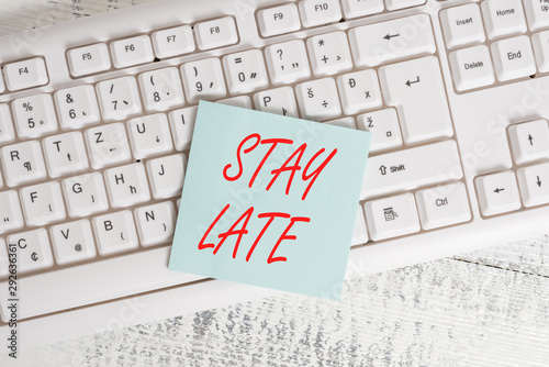 Conceptual hand writing showing Stay Late. Concept meaning A routine in which a demonstrating goes to somewhere out of time Keyboard office supplies rectangle shape paper reminder wood photo