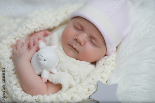 Baby newborn sleeping wrapped up in a blanket