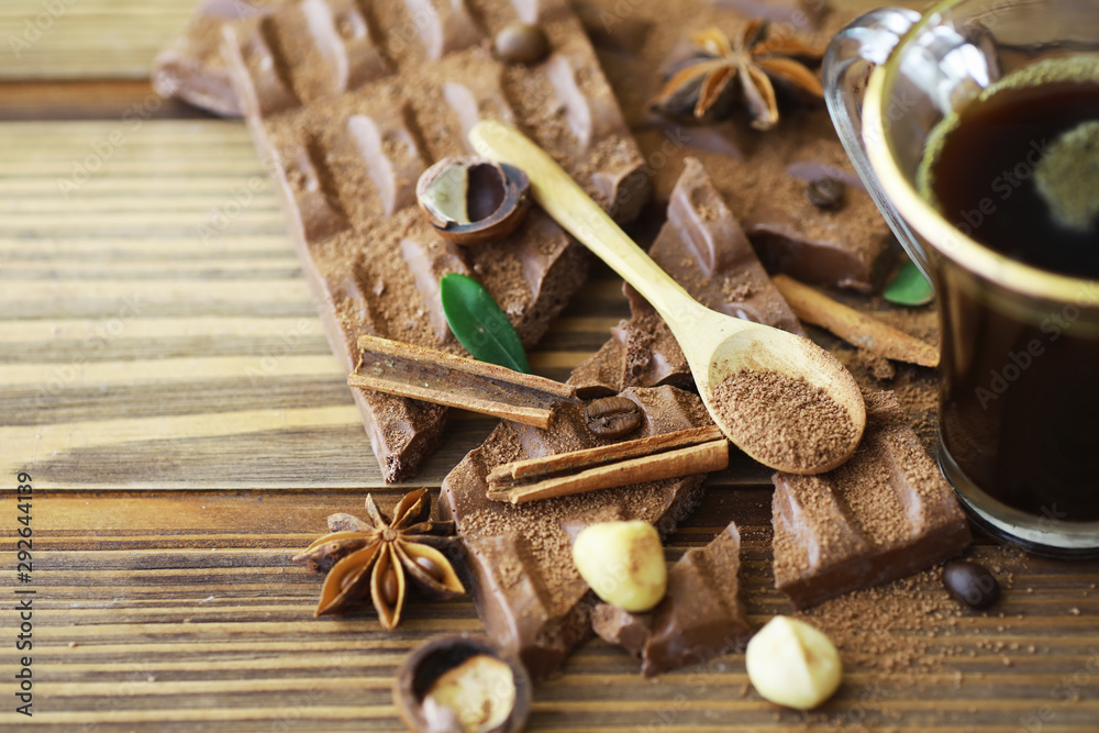 A bar of milk chocolate on the table. Chocolate with nuts and cinnamon.