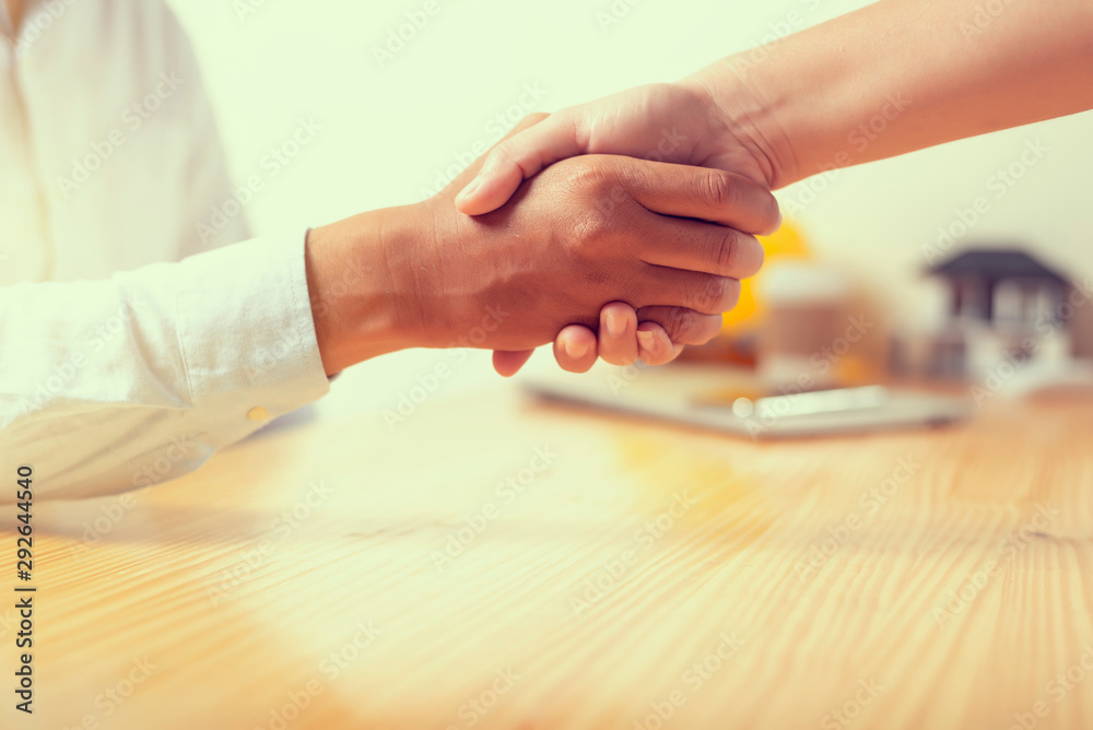 Asian architect man and businesswomen Handshaking.Successful businessmen handshaking after good deal.Handshake Gesturing People Connection Deal Concept.vintage color tone.
